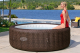 Bestway LAY-Z-SPA Energiespar-Whirlpool Bali AirJet mit App-Steuerung, für 7 Personen, Durchm. 216 x 71 cm, Rattan-Optik (Schokobraun)